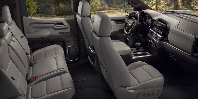Full interior view of a gray upscale pickup truck, showing the front passenger seat, dashboard, and rear seats